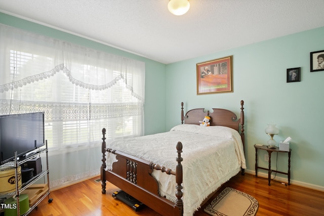 1401 Burchcrest Dr, Garner, NC 27529 - bedroom featuring wood finished floors and a textured ceiling