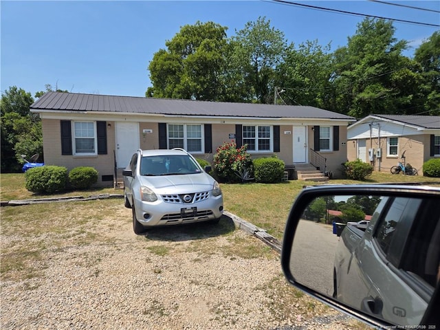 703 Lake Ave, Spring Lake, NC 28390 - ranch-style house with a metal roof and a front lawn