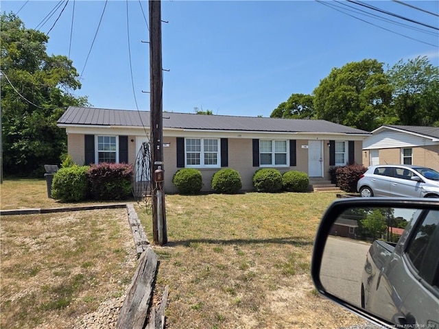 703 Lake Ave, Spring Lake, NC 28390 - ranch-style home with a metal roof, a front lawn, and brick siding