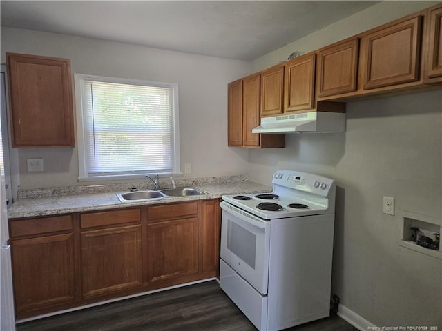 703 Lake Ave, Spring Lake, NC 28390 - kitchen with white electric stove, under cabinet range hood, brown cabinetry, dark wood-style flooring, and light countertops