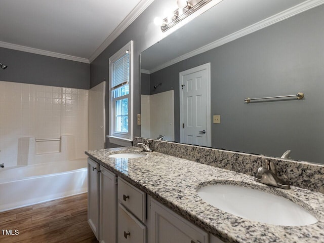 6020 Wildorlyn Cir, Raleigh, NC 27603 - full bath featuring double vanity, shower / bathtub combination, crown molding, and wood finished floors