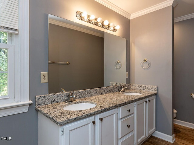 6020 Wildorlyn Cir, Raleigh, NC 27603 - bathroom with double vanity, wood finished floors, and crown molding