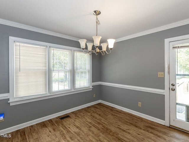 6020 Wildorlyn Cir, Raleigh, NC 27603 - unfurnished room with a chandelier, wood finished floors, and ornamental molding