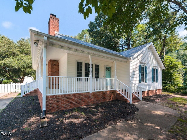 6020 Wildorlyn Cir, Raleigh, NC 27603 - view of front of home with covered porch, a chimney, and crawl space