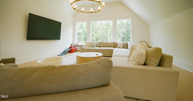 1620 Hunting Ridge Rd, Raleigh, NC 27615 - living area with lofted ceiling, a chandelier, and wood finished floors