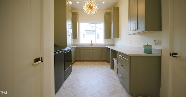 1620 Hunting Ridge Rd, Raleigh, NC 27615 - kitchen featuring a chandelier, brick patterned floors, light stone counters, and washer / dryer