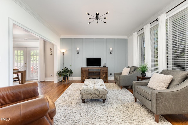 254 Charter Ct SE, Concord, NC 28025 - living room with ornamental molding, a chandelier, and wood finished floors