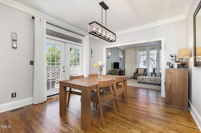 254 Charter Ct SE, Concord, NC 28025 - dining room with crown molding, french doors, plenty of natural light, wood finished floors, and a chandelier