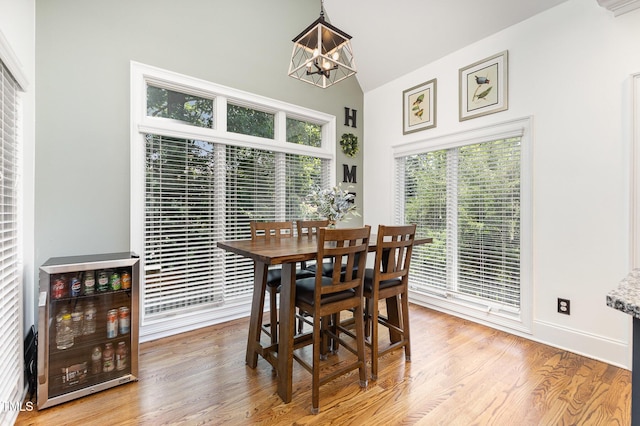 254 Charter Ct SE, Concord, NC 28025 - dining space with a chandelier, wood finished floors, and high vaulted ceiling