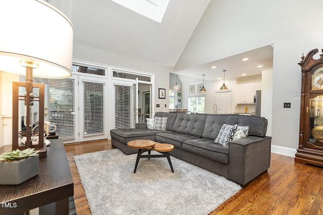 254 Charter Ct SE, Concord, NC 28025 - living area with a skylight, wood finished floors, high vaulted ceiling, and recessed lighting