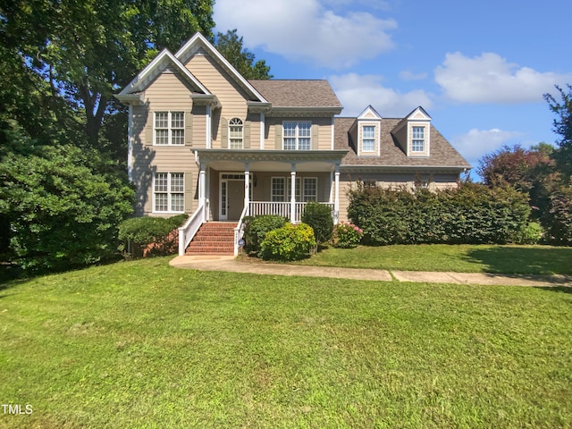 2408 Tiltonshire Ln, Apex, NC 27539 - view of front of house featuring covered porch, a front yard, and roof with shingles