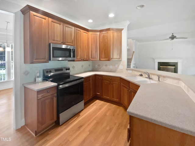2408 Tiltonshire Ln, Apex, NC 27539 - kitchen featuring stainless steel appliances, light wood finished floors, tasteful backsplash, recessed lighting, and ceiling fan