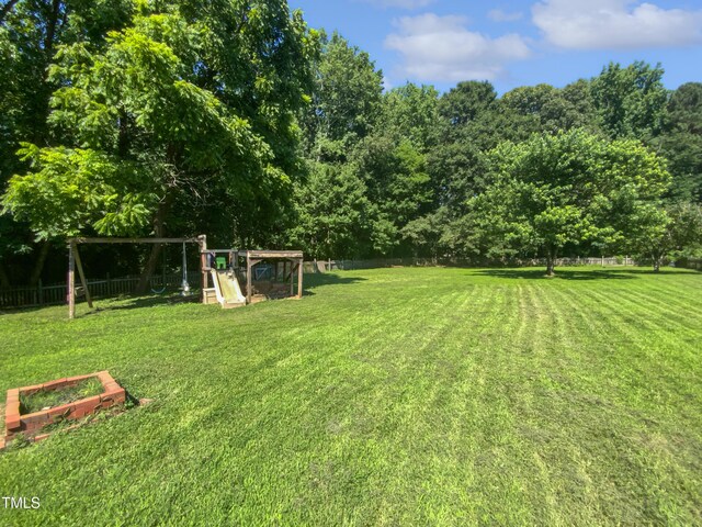 2408 Tiltonshire Ln, Apex, NC 27539 - fenced backyard featuring a playground