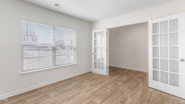 120 Leven Dr, Gibsonville, NC 27249 - unfurnished room featuring light wood-style flooring and french doors