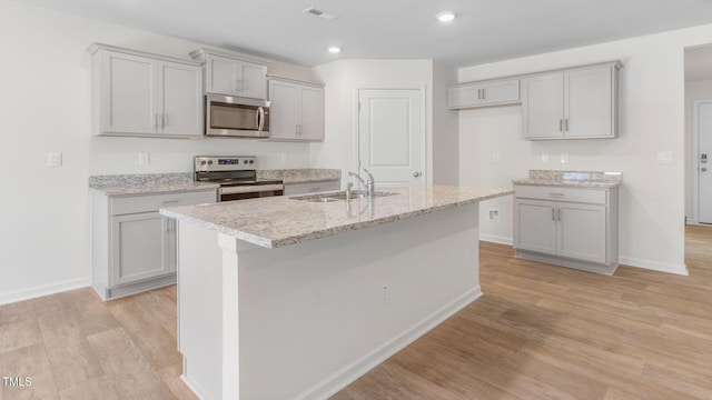 120 Leven Dr, Gibsonville, NC 27249 - kitchen featuring stainless steel appliances, gray cabinetry, light wood-style floors, and recessed lighting