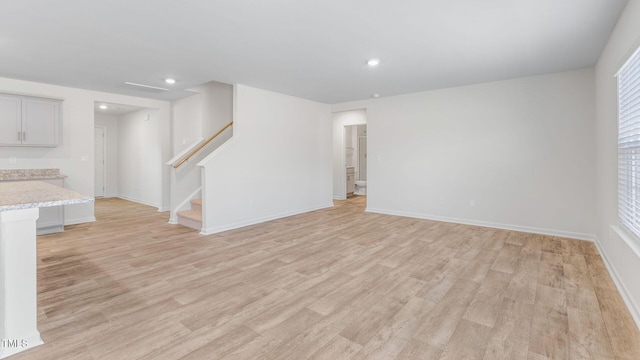 120 Leven Dr, Gibsonville, NC 27249 - unfurnished living room featuring stairway, light wood finished floors, and recessed lighting