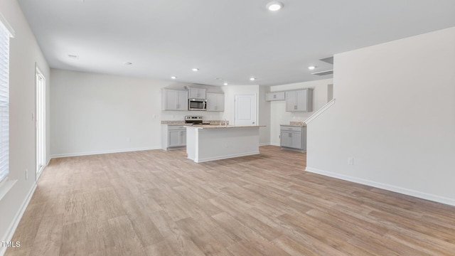 120 Leven Dr, Gibsonville, NC 27249 - unfurnished living room with light wood finished floors and recessed lighting