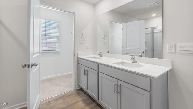 120 Leven Dr, Gibsonville, NC 27249 - bathroom with double vanity, wood finished floors, and an enclosed shower