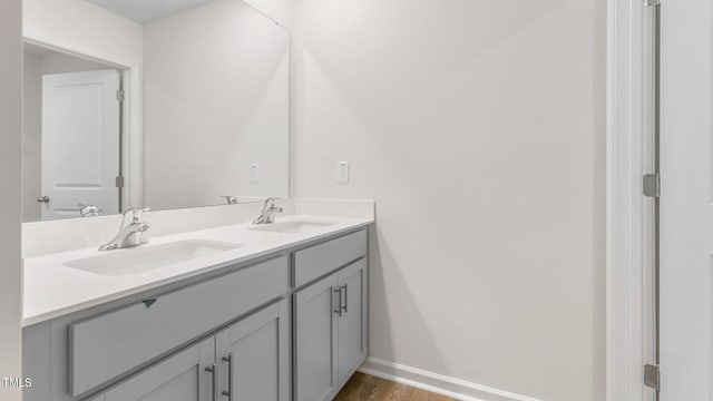120 Leven Dr, Gibsonville, NC 27249 - bathroom with double vanity and wood finished floors