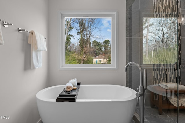 505 Colleton Rd, Raleigh, NC 27610 - bathroom featuring a soaking tub, tile patterned floors, and tiled shower