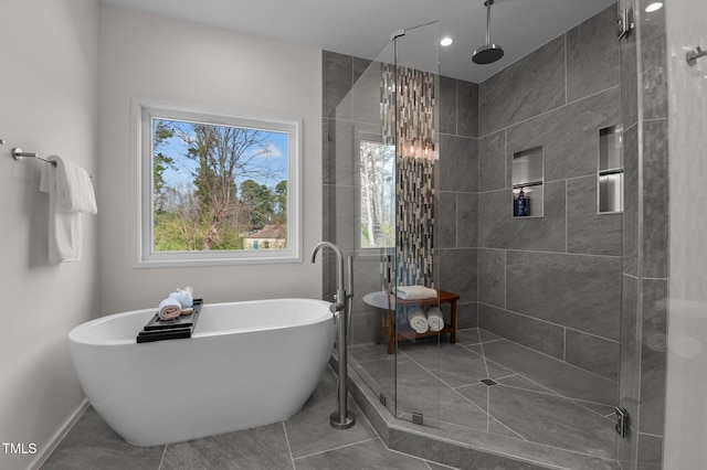 505 Colleton Rd, Raleigh, NC 27610 - bathroom featuring a stall shower, a freestanding tub, and tile patterned flooring