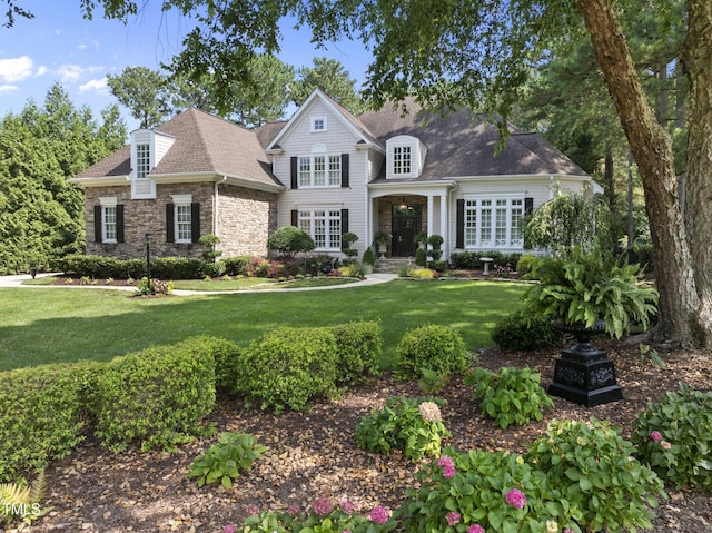 8416 Davishire Dr, Raleigh, NC 27615 - view of front of home featuring stone siding, a front lawn, and a shingled roof