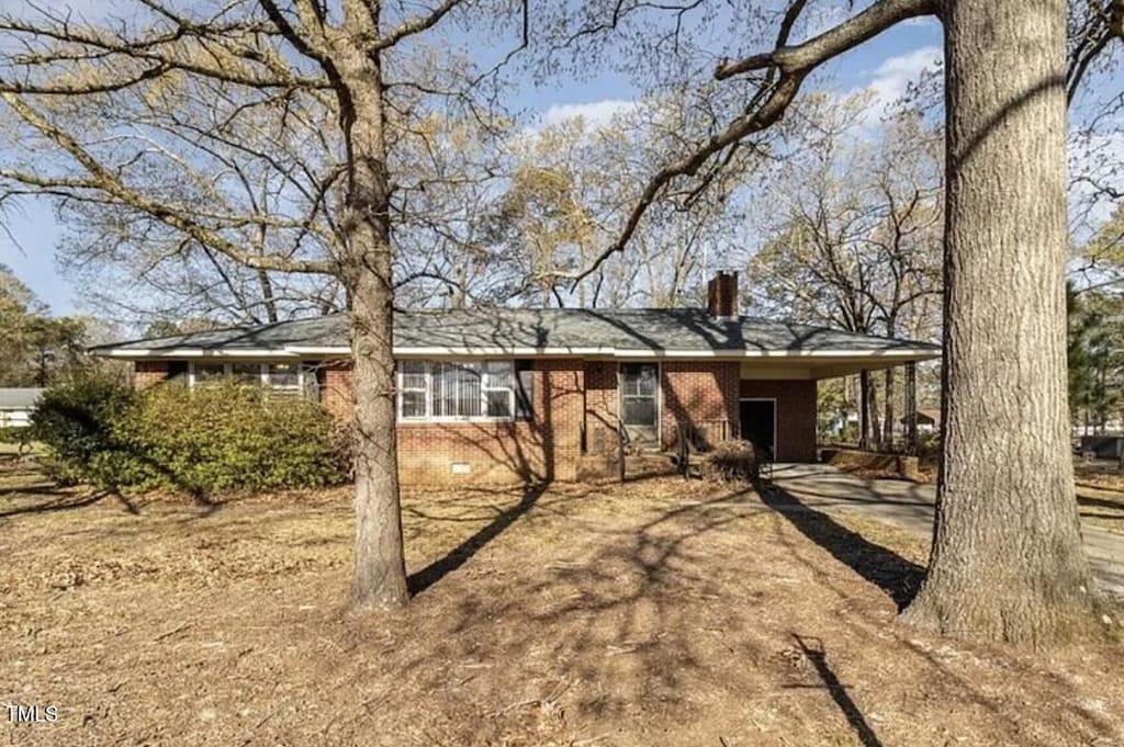 203 Ervin Dr, Goldsboro, NC 27534 - view of front of property with a chimney, a carport, crawl space, and driveway