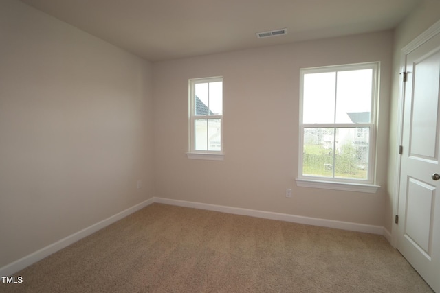 912 Montague Ave, Durham, NC 27703 - empty room with light colored carpet and healthy amount of natural light