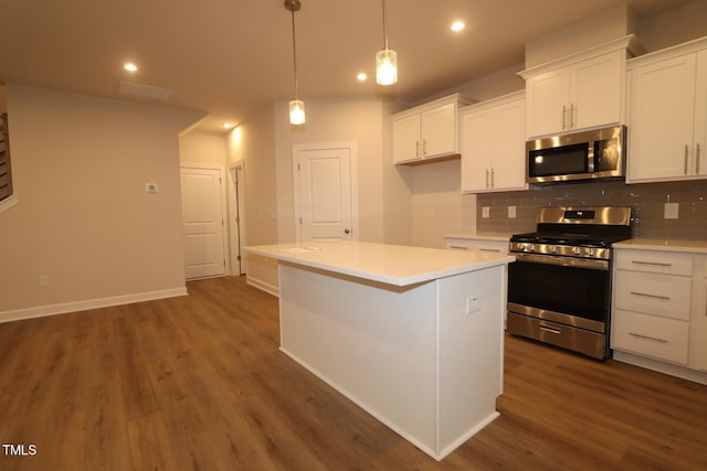 912 Montague Ave, Durham, NC 27703 - kitchen with stainless steel appliances, recessed lighting, tasteful backsplash, dark wood-style floors, and white cabinets