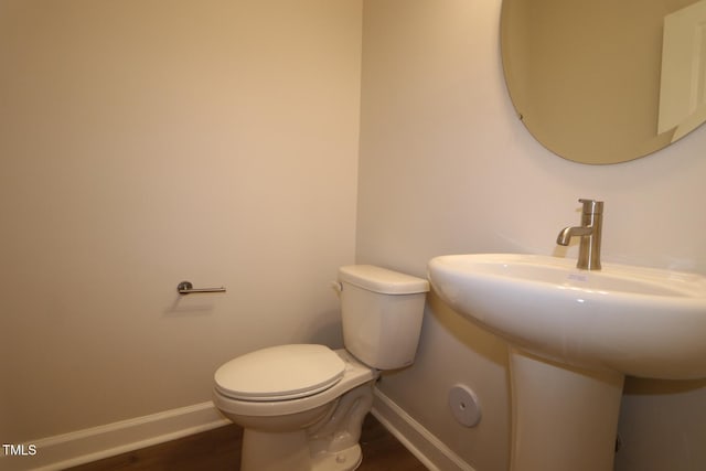 912 Montague Ave, Durham, NC 27703 - bathroom featuring toilet and wood finished floors