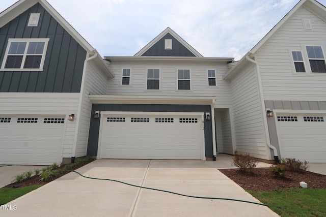 912 Montague Ave, Durham, NC 27703 - view of front of property featuring board and batten siding, an attached garage, and concrete driveway