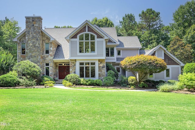 267 Bald Eagle Dr, Pittsboro, NC 27312 - craftsman-style home featuring stone siding, a front yard, roof with shingles, and a chimney
