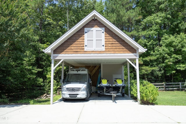 267 Bald Eagle Dr, Pittsboro, NC 27312 - view of parking / parking lot featuring driveway, a carport, and view of wooded area