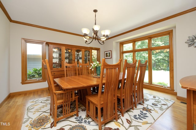267 Bald Eagle Dr, Pittsboro, NC 27312 - dining area with a chandelier, crown molding, and light wood-type flooring