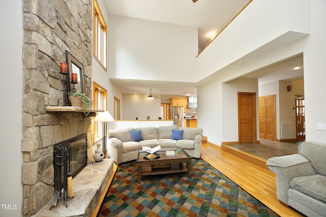 267 Bald Eagle Dr, Pittsboro, NC 27312 - living area with a stone fireplace, wood finished floors, and a towering ceiling