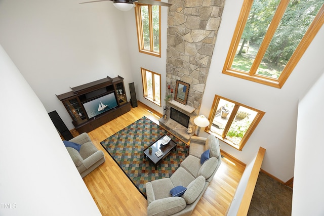 267 Bald Eagle Dr, Pittsboro, NC 27312 - living area with a stone fireplace, a high ceiling, wood finished floors, and ceiling fan