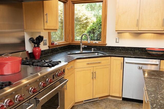 267 Bald Eagle Dr, Pittsboro, NC 27312 - kitchen with stainless steel appliances, dark stone countertops, and light brown cabinetry