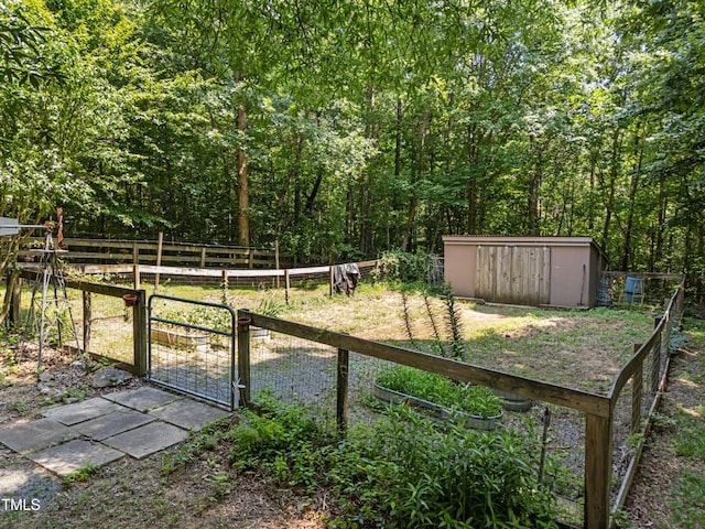 267 Bald Eagle Dr, Pittsboro, NC 27312 - view of yard featuring a gate, a shed, and a forest view