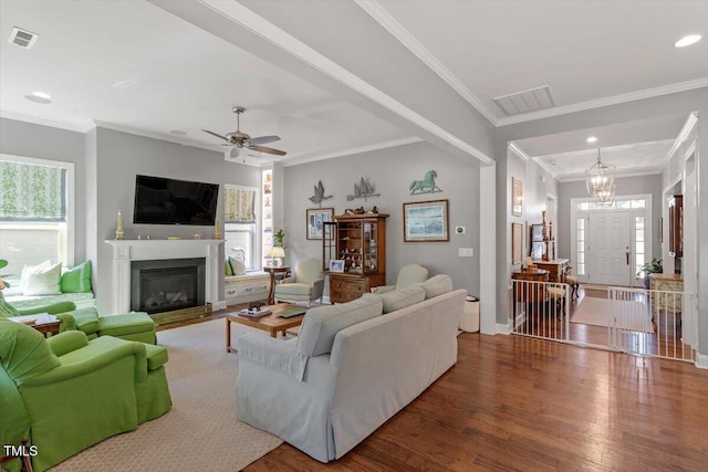 1217 Clandon Square Rd, Hillsborough, NC 27278 - living room with plenty of natural light, wood finished floors, a glass covered fireplace, crown molding, and recessed lighting
