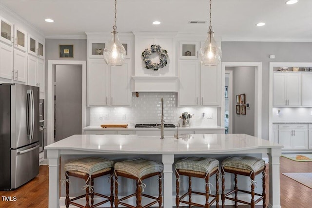 1217 Clandon Square Rd, Hillsborough, NC 27278 - kitchen with freestanding refrigerator, white cabinets, a kitchen bar, light countertops, and dark wood-type flooring