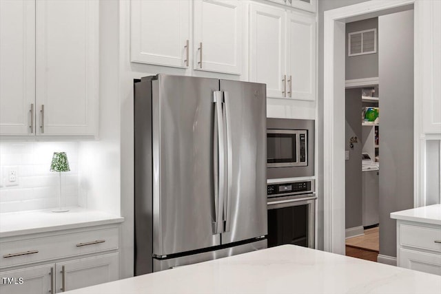 1217 Clandon Square Rd, Hillsborough, NC 27278 - kitchen with appliances with stainless steel finishes, white cabinets, backsplash, and light stone countertops