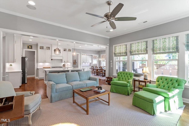 1217 Clandon Square Rd, Hillsborough, NC 27278 - living area with wood finished floors, ceiling fan, recessed lighting, and crown molding