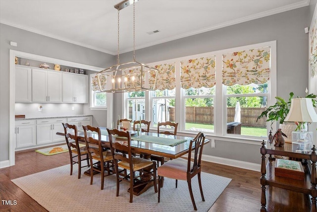 1217 Clandon Square Rd, Hillsborough, NC 27278 - dining space with crown molding, dark wood-style flooring, and a chandelier