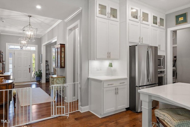 1217 Clandon Square Rd, Hillsborough, NC 27278 - kitchen featuring appliances with stainless steel finishes, dark wood finished floors, crown molding, white cabinetry, and light countertops