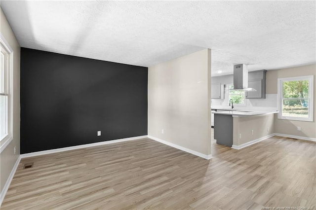 1718 Shiloh Dr, Fayetteville, NC 28304 - unfurnished living room with a textured ceiling and light wood finished floors