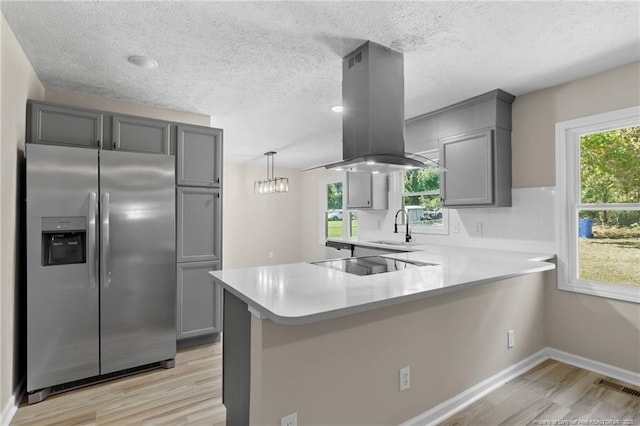 1718 Shiloh Dr, Fayetteville, NC 28304 - kitchen featuring stainless steel fridge with ice dispenser, island range hood, gray cabinets, light wood-type flooring, and light countertops
