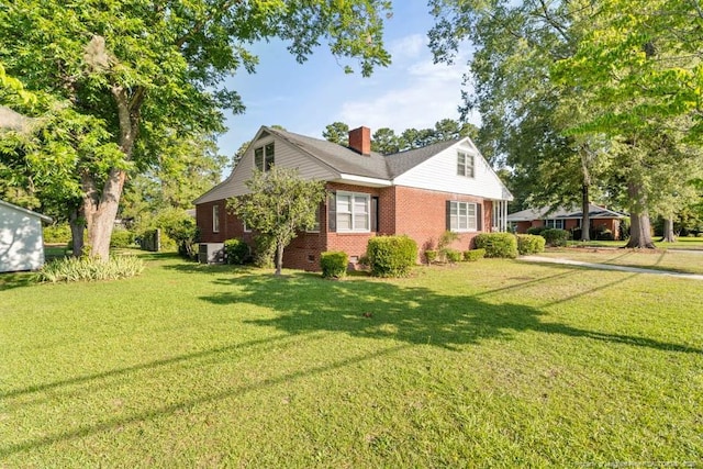 1905 N Rowland Ave N, Lumberton, NC 28358 - view of front of home with a chimney, a front yard, and brick siding