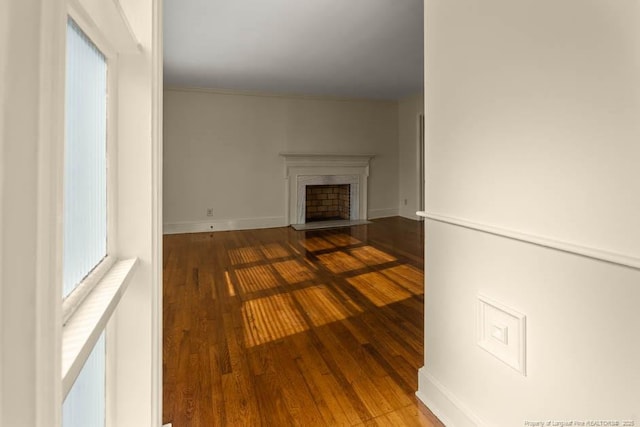 1905 N Rowland Ave N, Lumberton, NC 28358 - unfurnished living room with wood finished floors and a fireplace