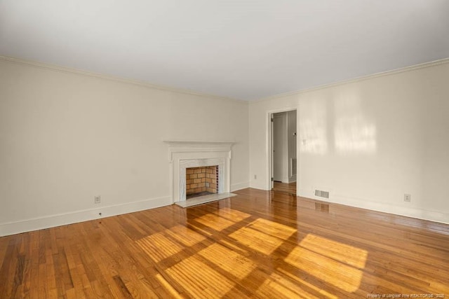 1905 N Rowland Ave N, Lumberton, NC 28358 - unfurnished living room with wood finished floors, ornamental molding, and a fireplace