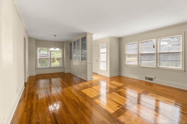 1905 N Rowland Ave N, Lumberton, NC 28358 - unfurnished living room featuring a chandelier and wood finished floors